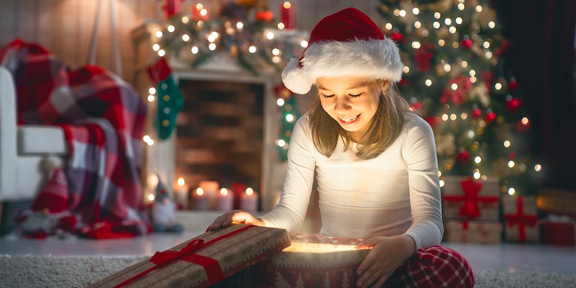 Excited child opening a Christmas gift