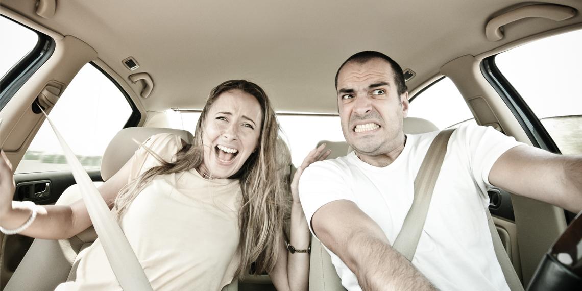 two people looking feraful in a car