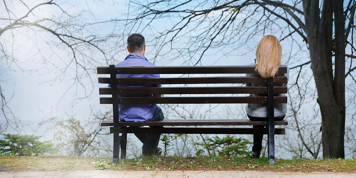 a man and a woman sitting on a bench