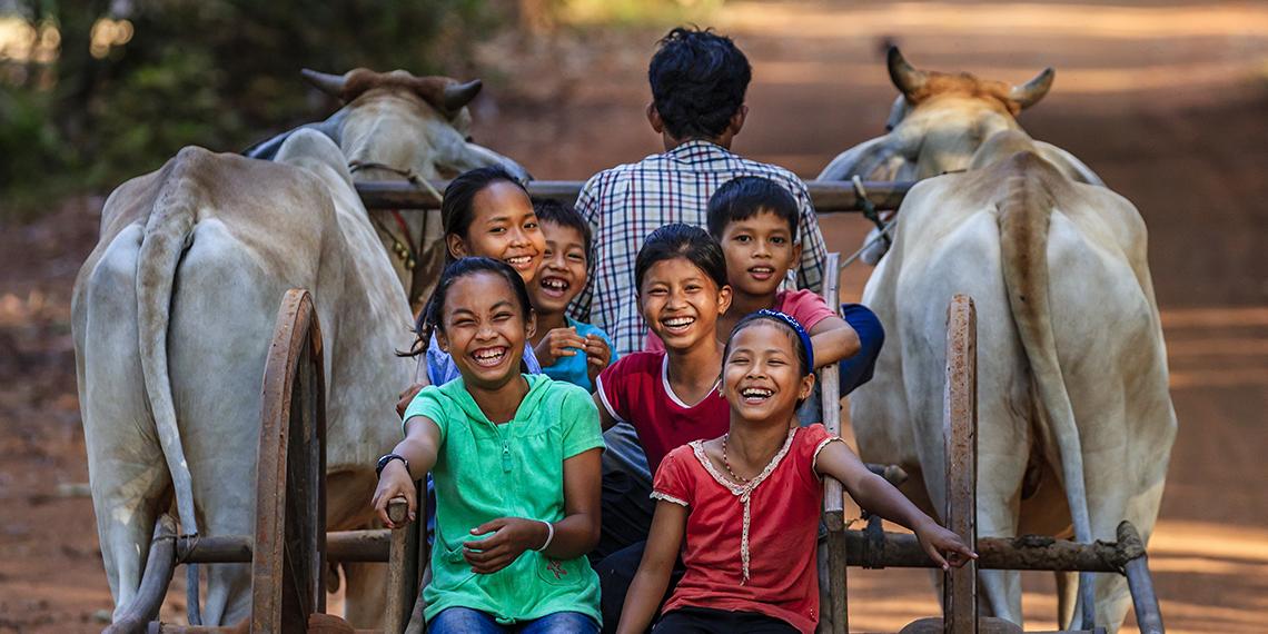 Cambodian children travelling on a cart