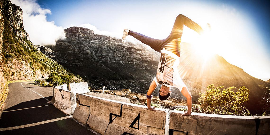 Youth doing handstand on wall