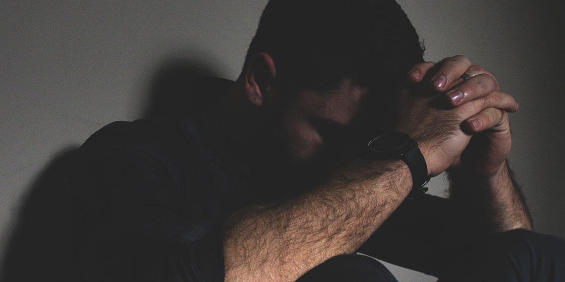 Man in darkness praying