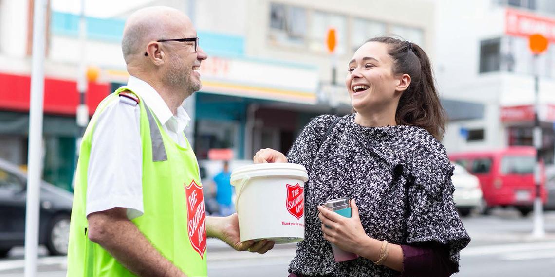Woman happily giving to the Red Shield street appeal