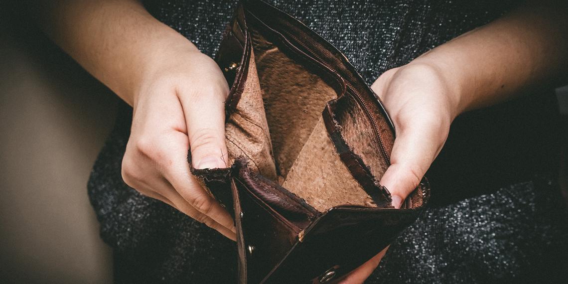 a woman holding an empty wallet