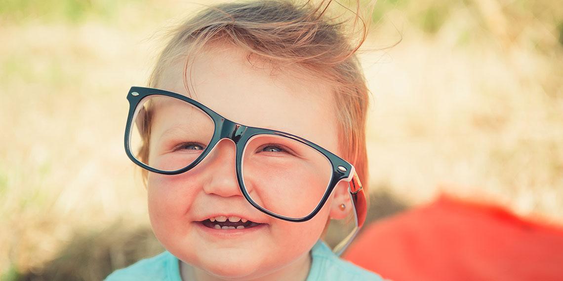 kid wearing glasses funny