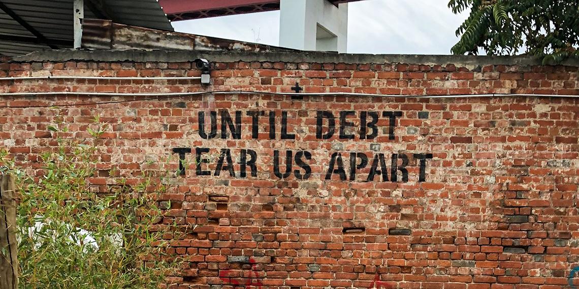 graffiti on wall "until debt tear us apart"