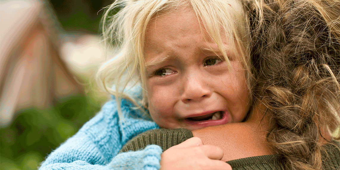 Crying child comforted by mother