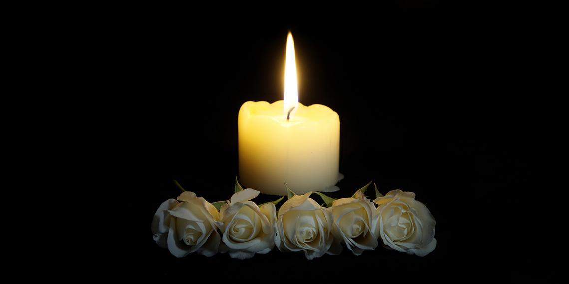 Candle burning in the darkness