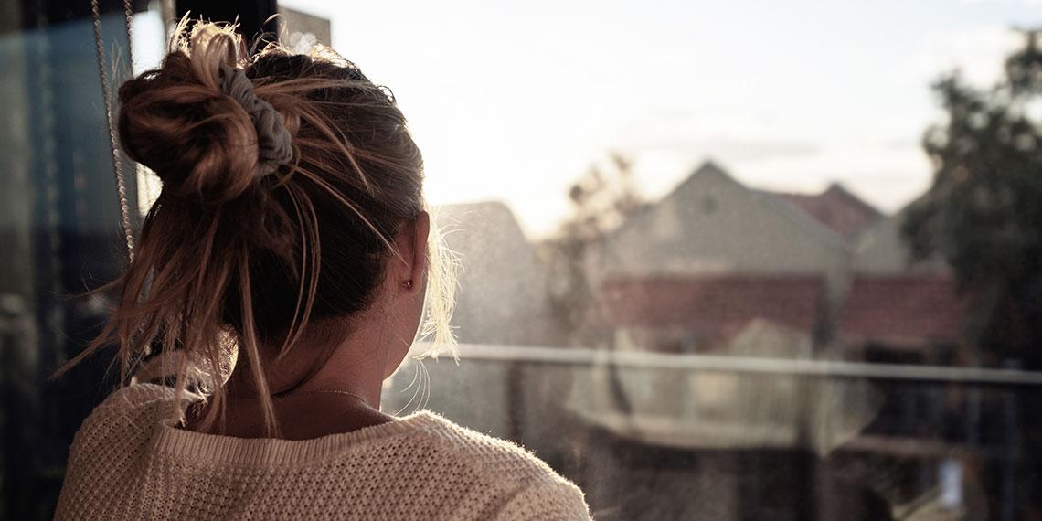Woman looking out window