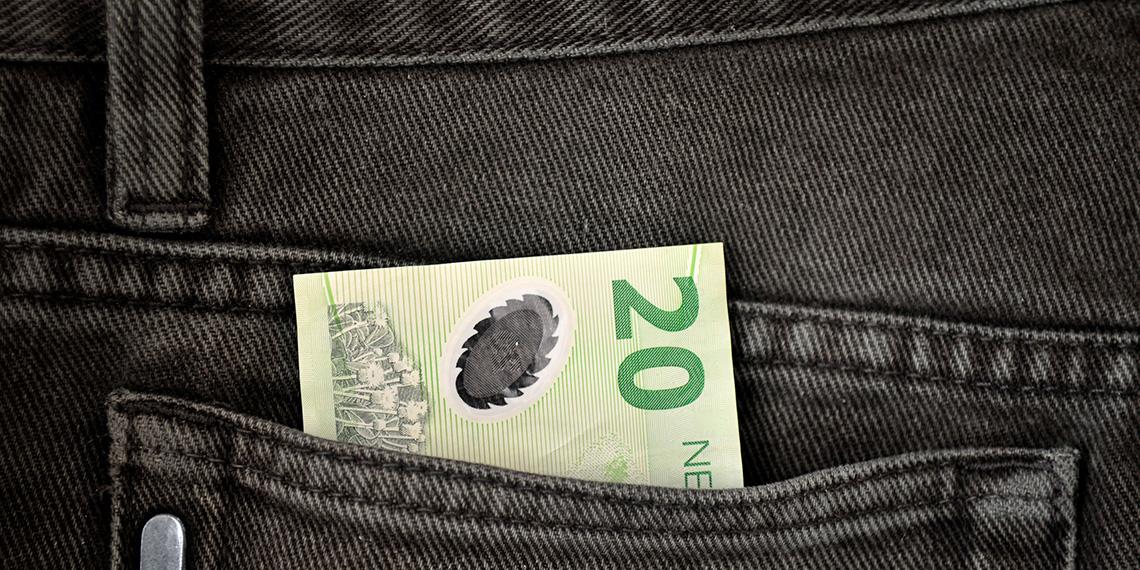 20 dollar note sticking out of jean pocket
