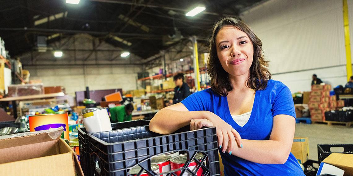 Lady in foodbank warehouse