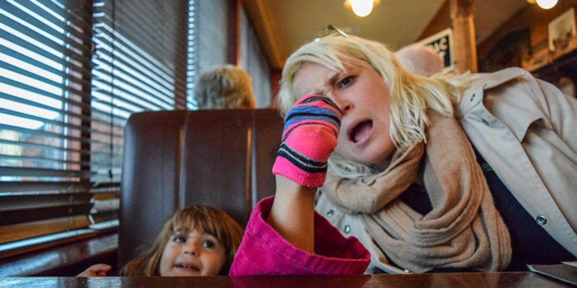 a little girld and mother in a cafe