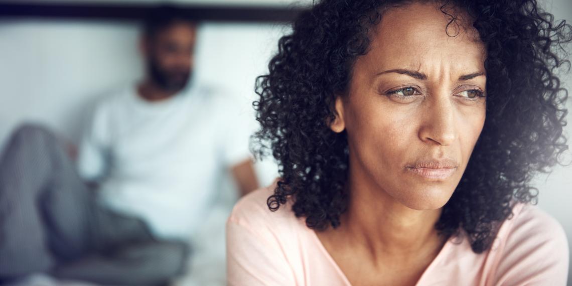  a woman looking anxious in a room with a man